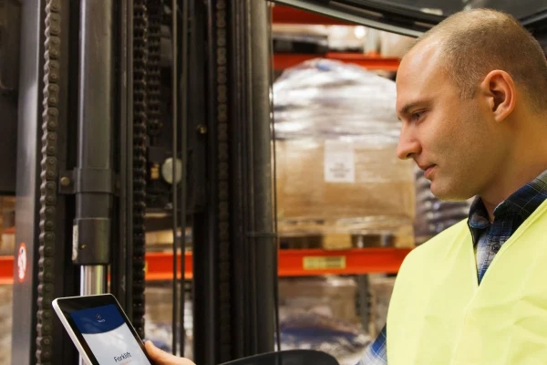 man with tablet and forklift or loader loading boxes at warehouse truce | SPIRIT/21