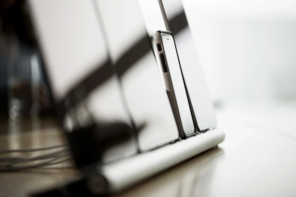 mehrere mobile Ger&auml;te die in einer Reihe aufgestellt sind und das Licht von drau&szlig;en in ihrem Bildschirm reflektieren | SPIRIT/21